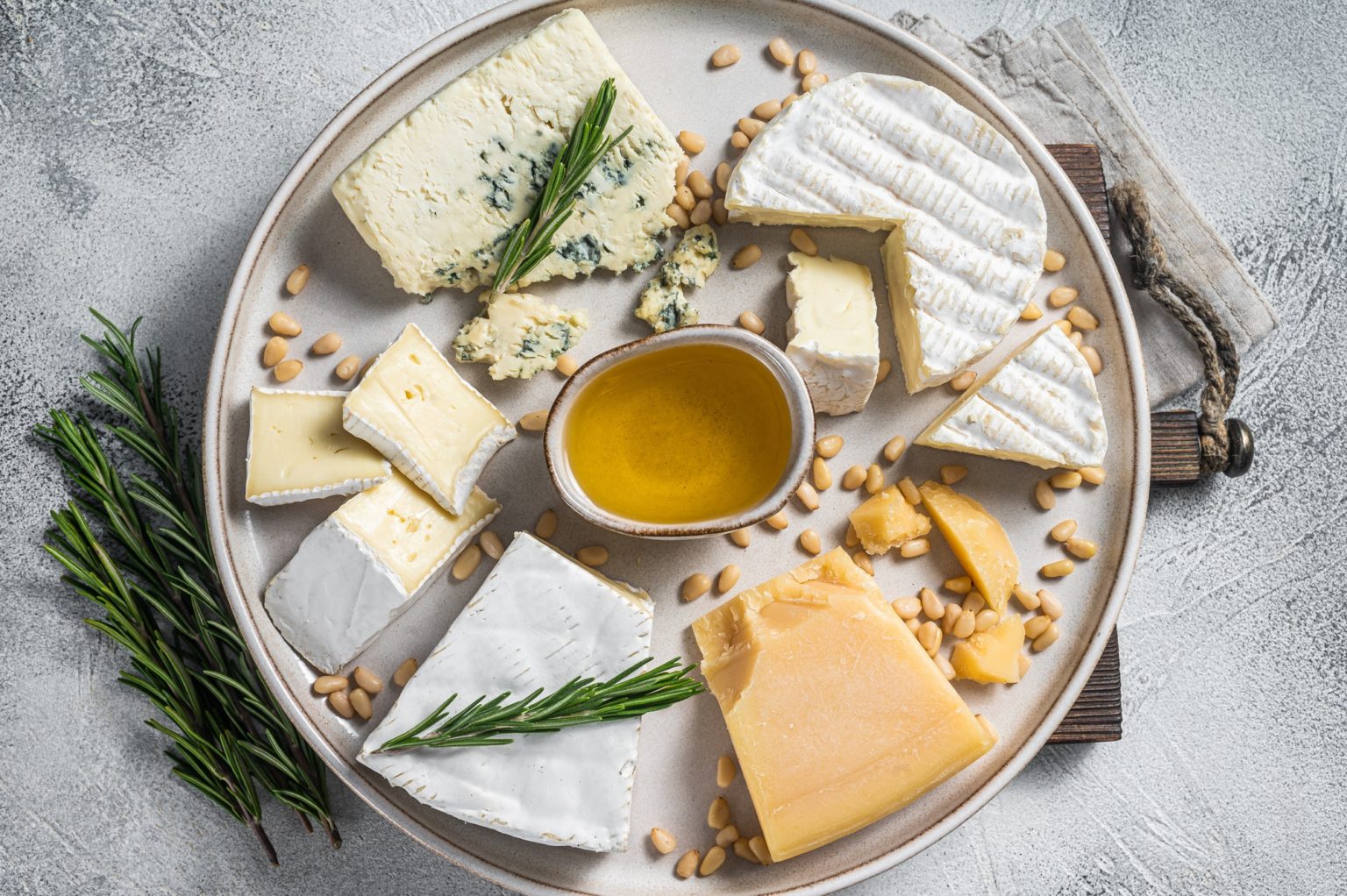 French Cheese platter with camembert, brie, Gorgonzola, parmesan, honey, nuts and herbs