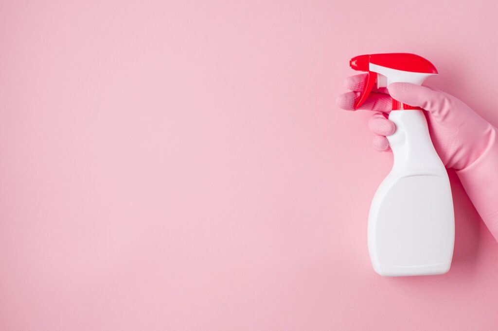 Detergents and cleaning accessories in pastel color. Cleaning service, small business idea. Top view